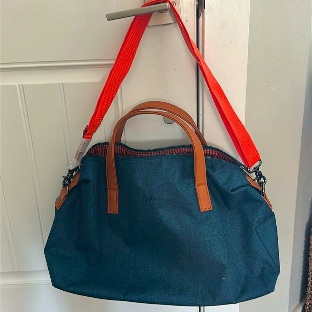 Epic brand bag. Blue bag with orange strap, navy and orange striped interior.
